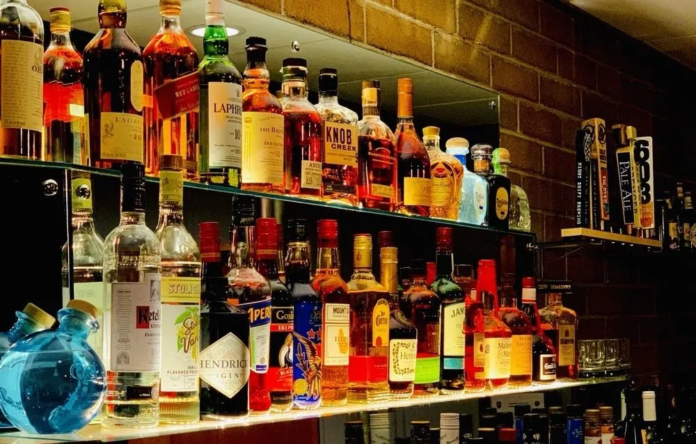 The Den — brick walls, retro stools at the bar, conversation lounge